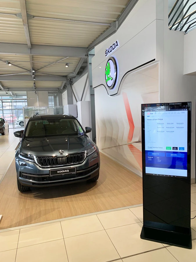 Digitálny panel vedľa vozidla Škoda Kodiaq v showroome TUkas – realizácia Digitálne panely CZ
